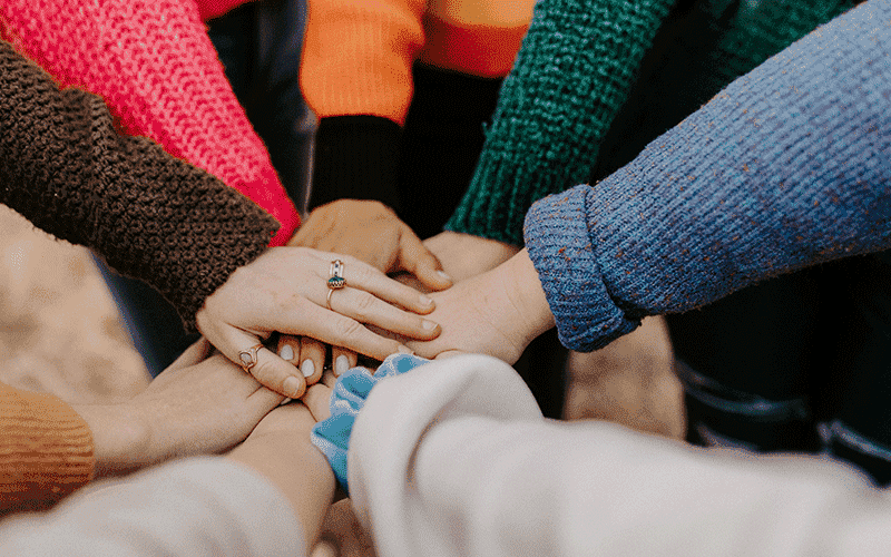 A group of hands interlocking